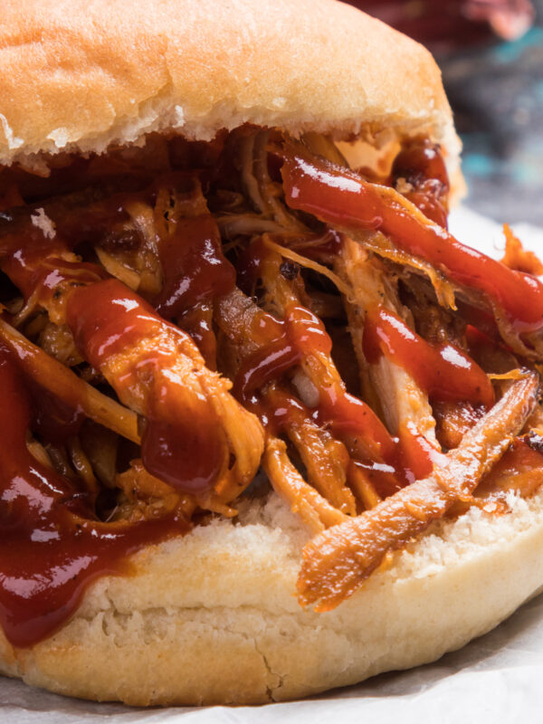 A close-up image of a pulled pork sandwich