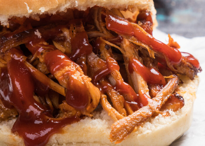 A close-up image of a pulled pork sandwich