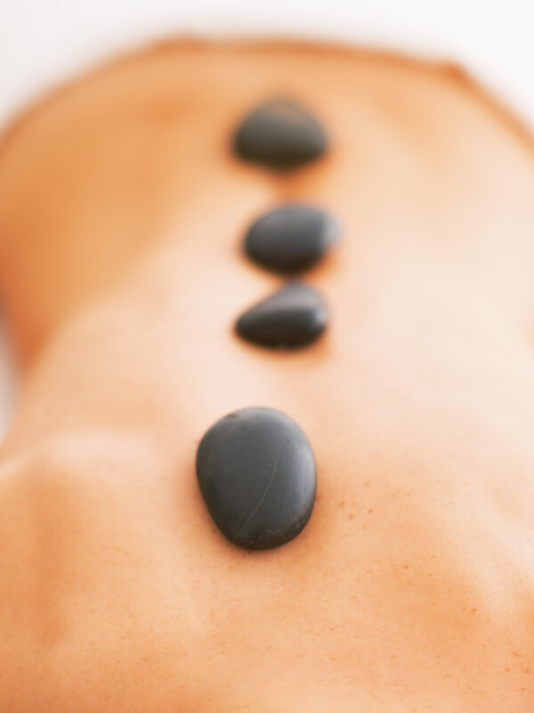 An image of a woman getting a hot stone treatment