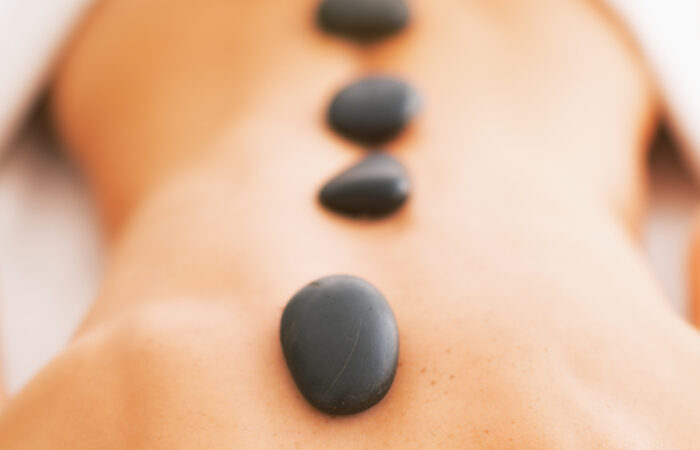 An image of a woman getting a hot stone treatment