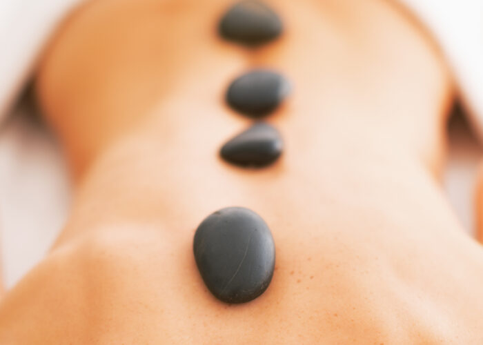 An image of a woman getting a hot stone treatment