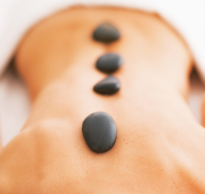 An image of a woman getting a hot stone treatment