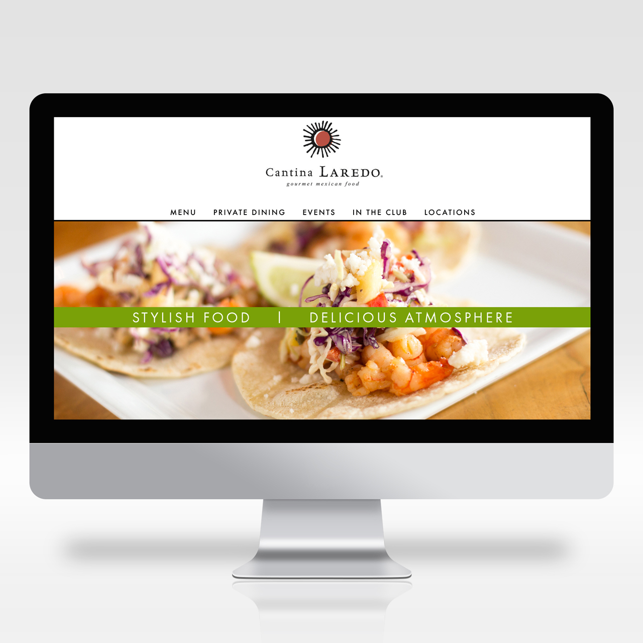 An image of a computer with the home page design for Cantina Laredo's website