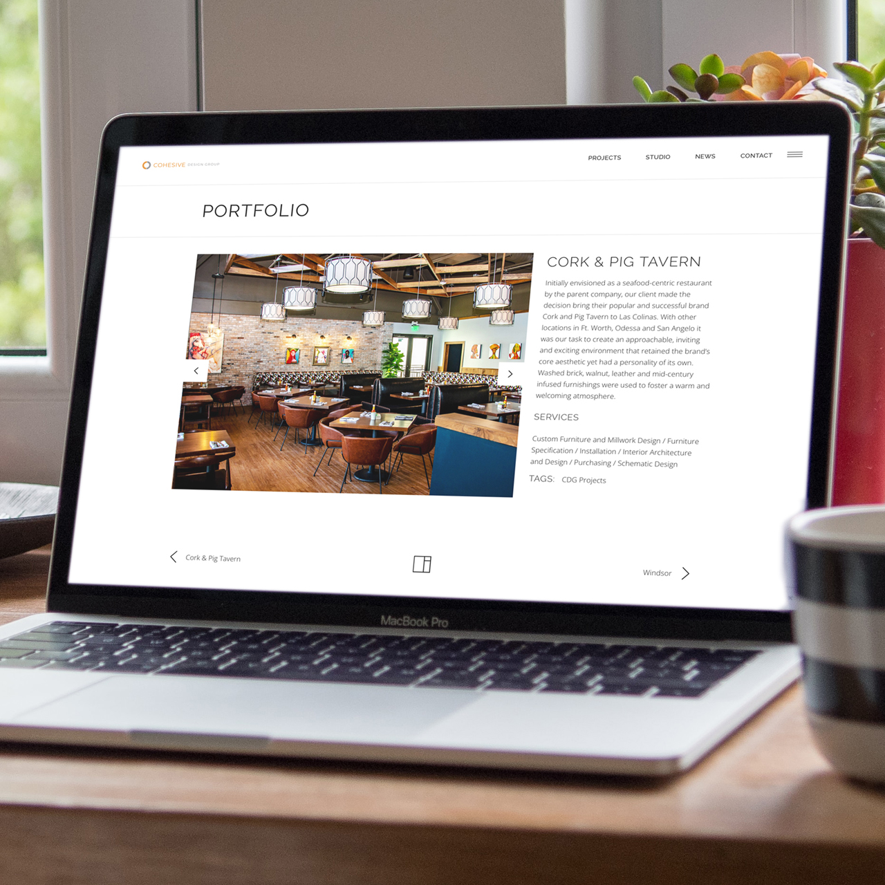 An image of a laptop with a project page design from Cohesive Design Group's website