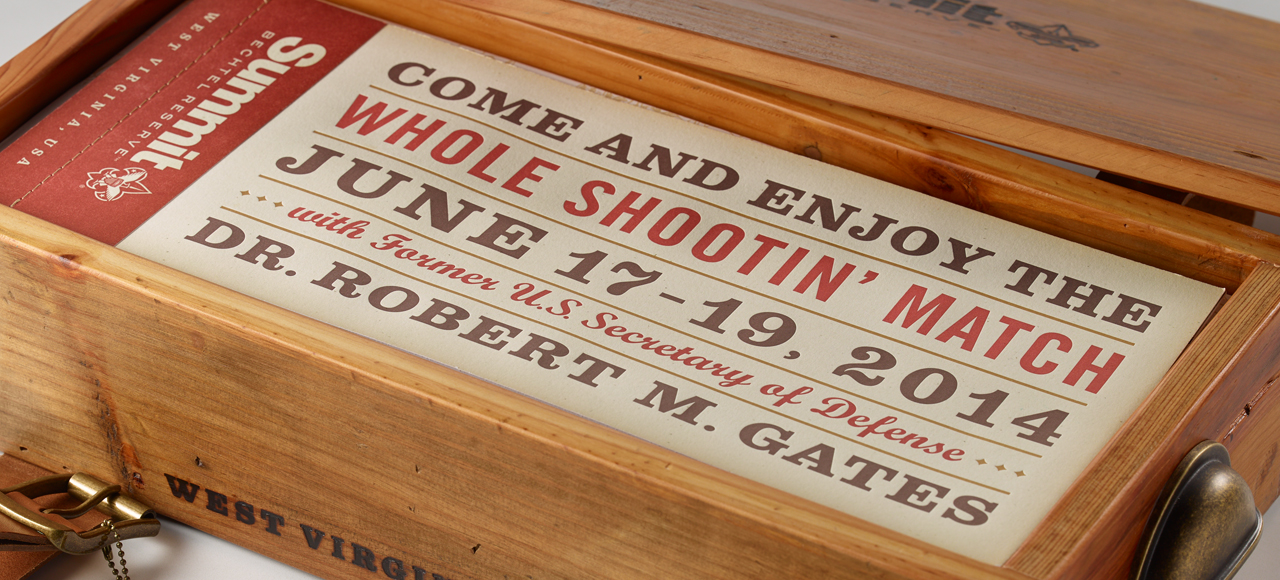 An image of an invitation booklet inside of a wooden gift box