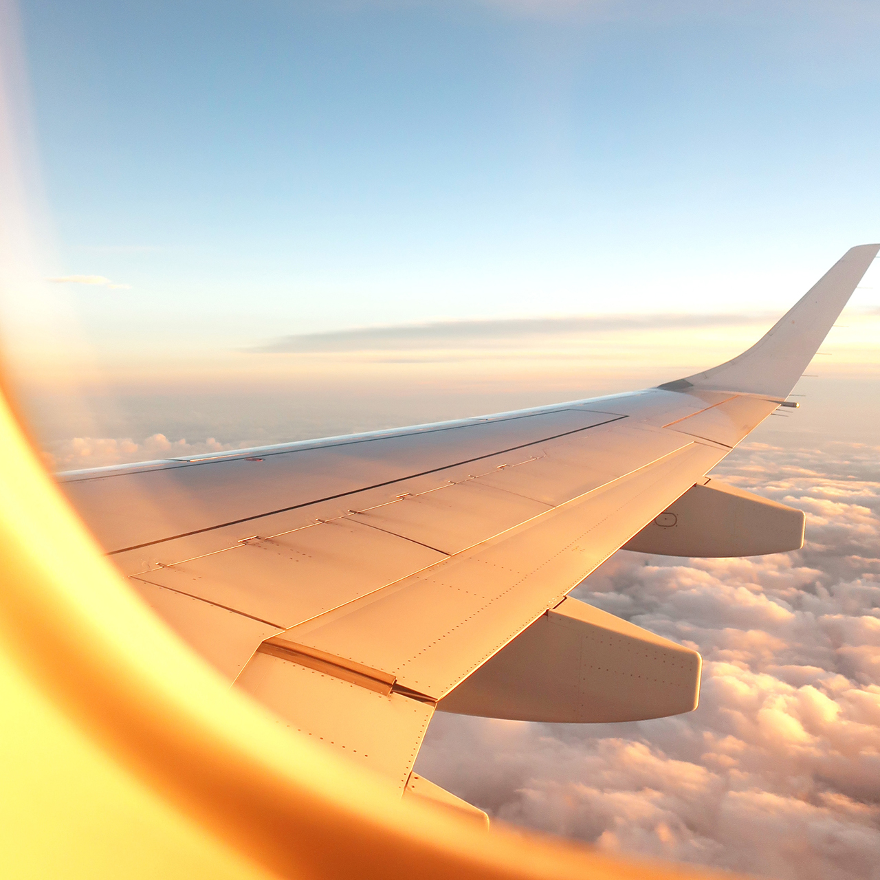 Image of an airplane wing looking out the window of the plane